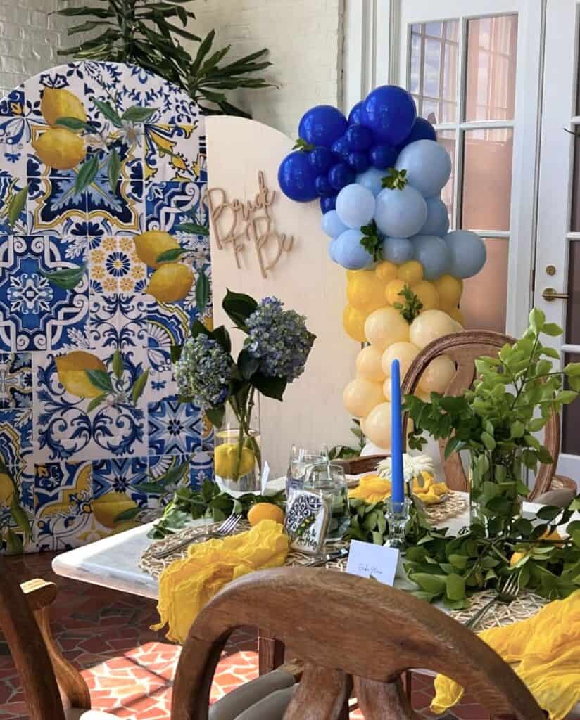 Vibrant lemon and blue balloon backdrop for summer celebration at Confetti & Roses.