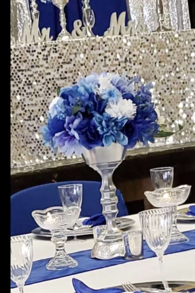 Elegant blue and white floral centerpiece for wedding reception.