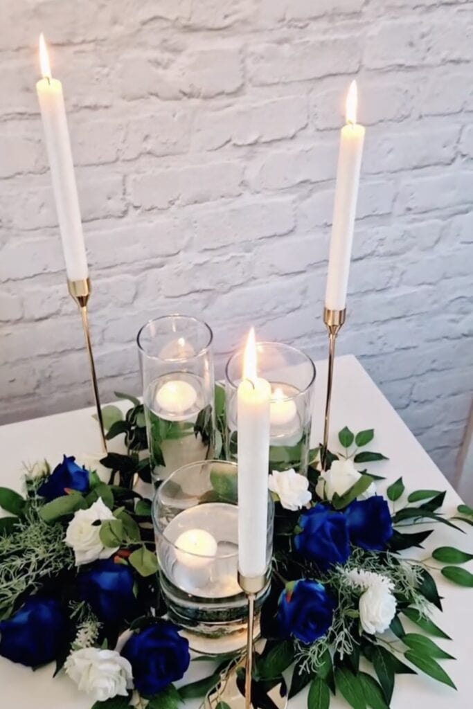 Elegant candle and floral centerpiece for weddings and events.