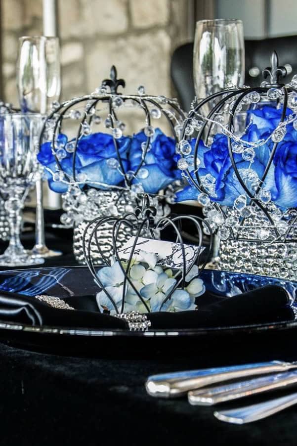 Elegant blue floral centerpiece with crystal accents for wedding decor.