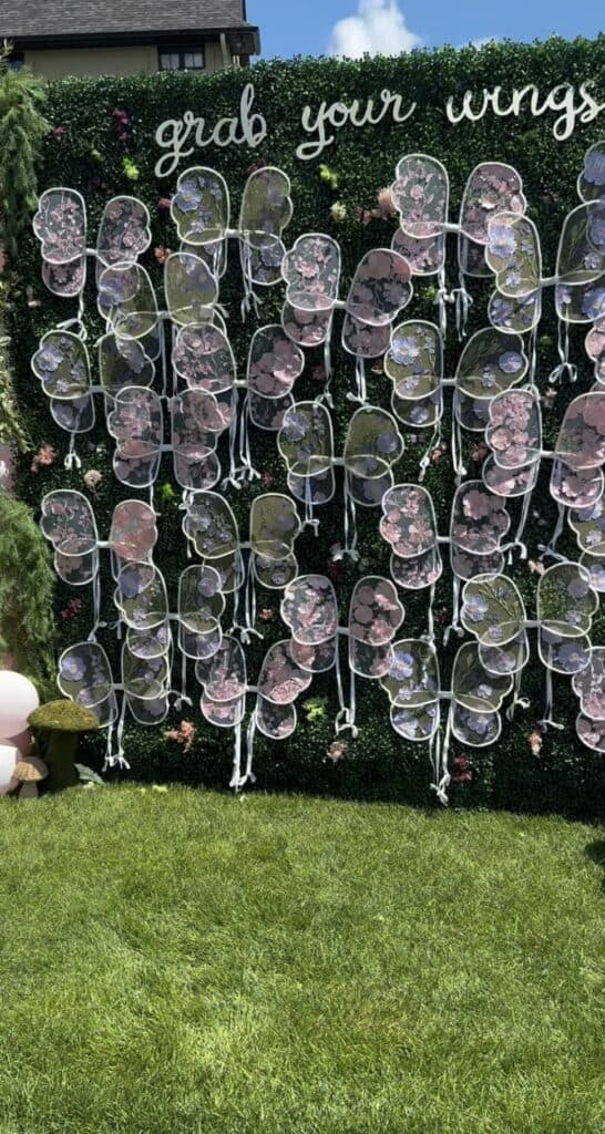 Colorful floral shoes display for wedding or event decor, outdoor garden backdrop.