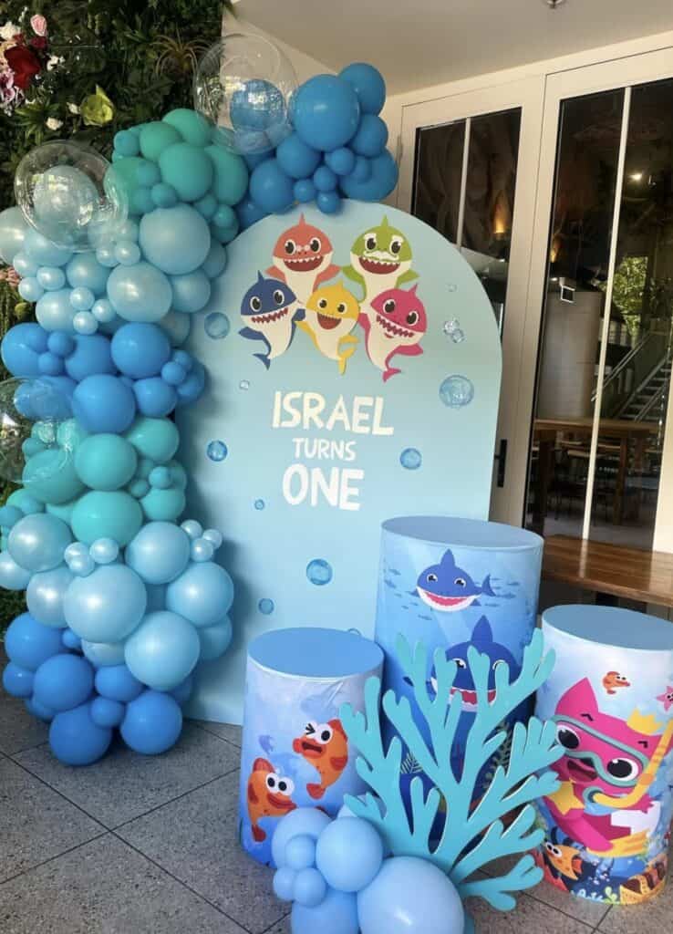 Colorful Underwater Themed First Birthday Party Decorations with Balloons and Ocean Characters.