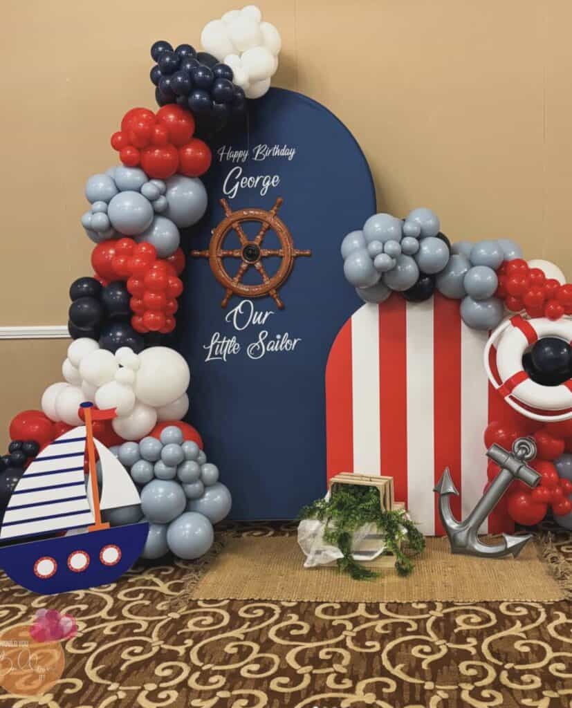 Colorful nautical themed balloon display with "Happy Birthday George" sign.