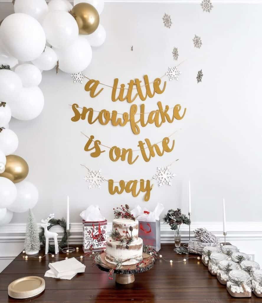 Festive winter holiday dessert table with snowflake decor and balloons.