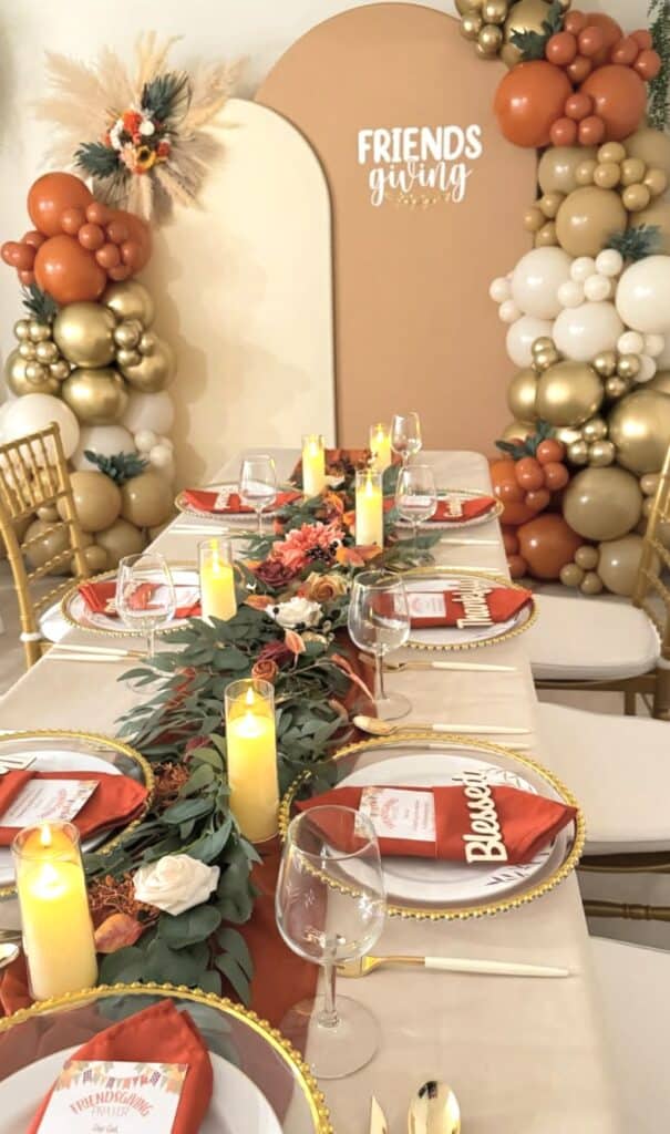 Balloon garland and floral centerpiece for friendsgiving celebration.