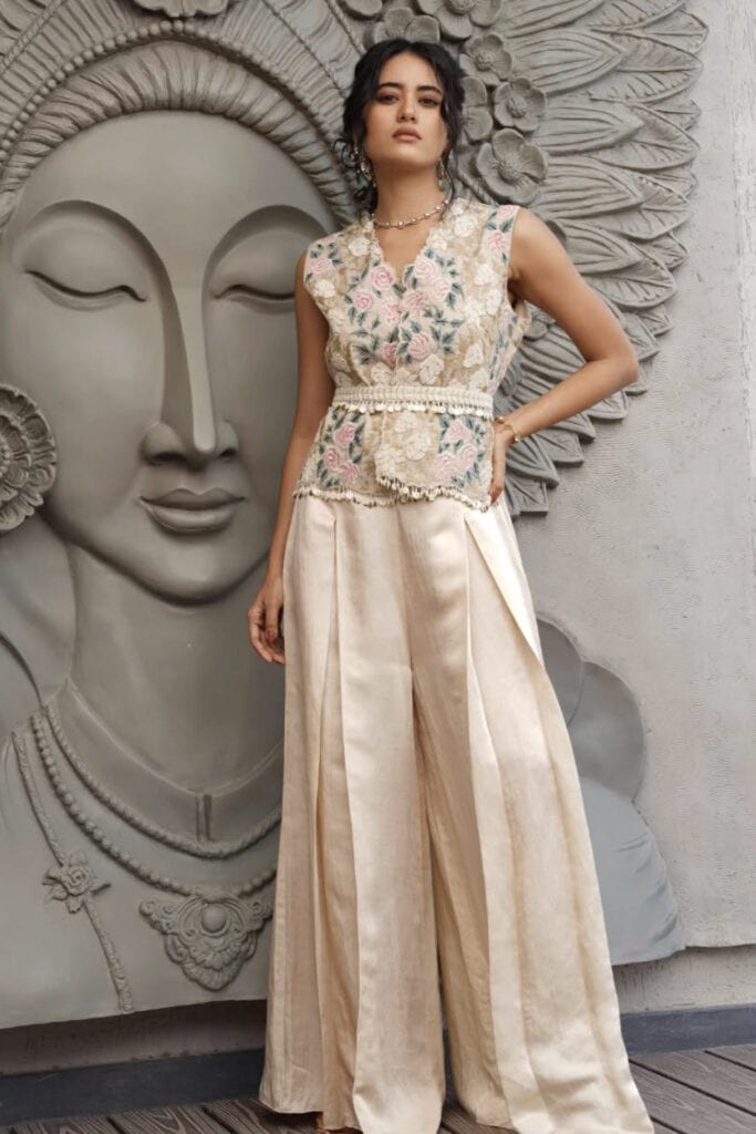 Elegant embroidered floral top and wide-leg satin pants, stylish boho chic outfit.