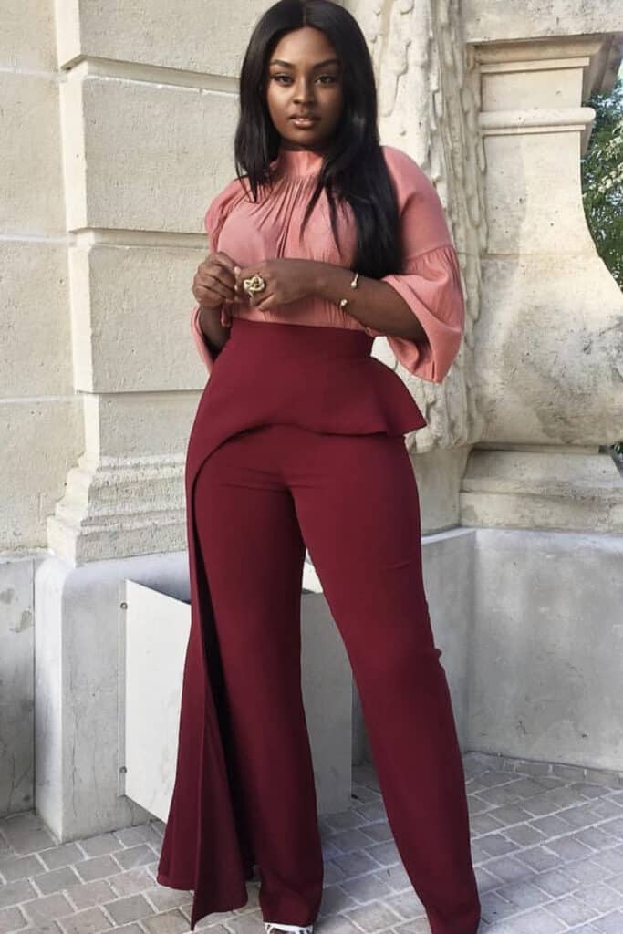 Burgundy formal wide-leg pants and pink chiffon blouse, elegant women's fashion, confetti and roses, stylish outfit, urban background.