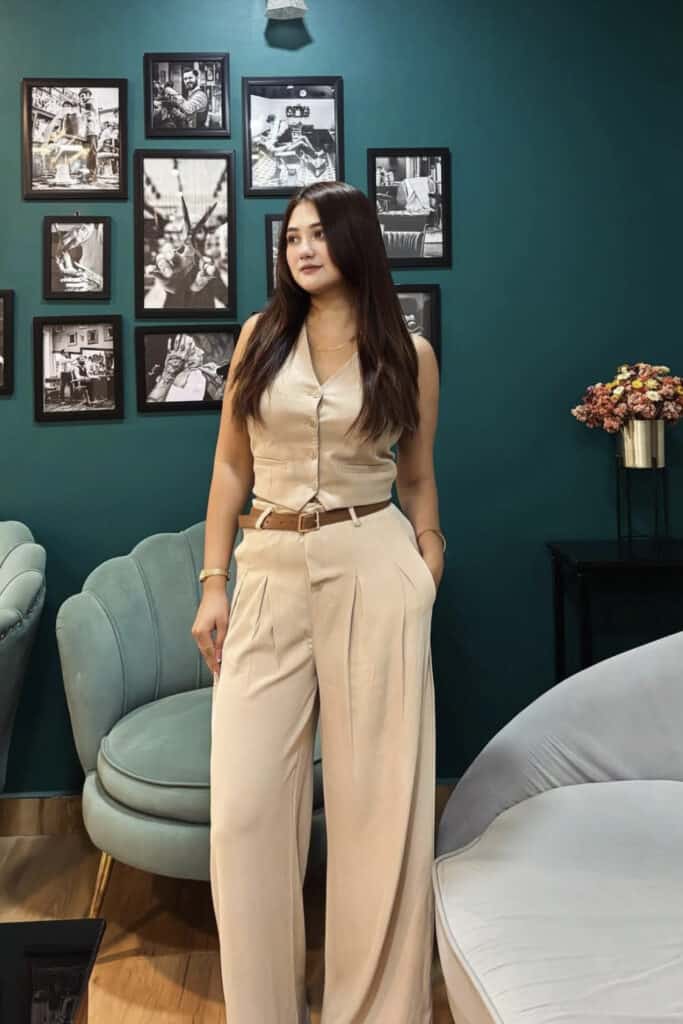 Elegant woman in beige outfit at Confetti & Roses event.