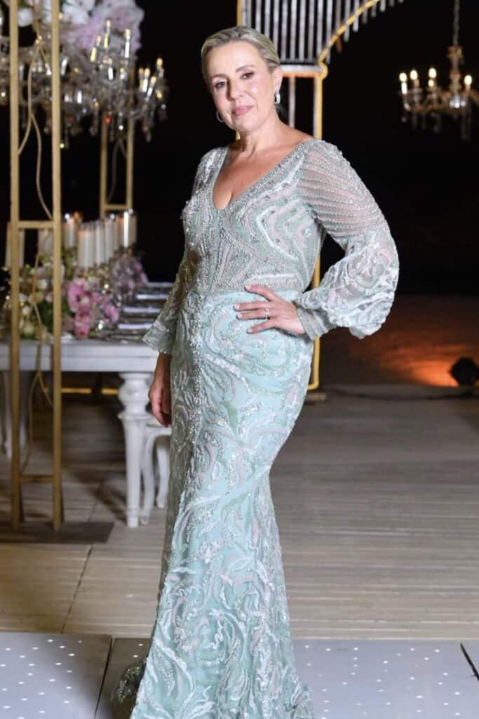 Elegant woman in wedding dress at confetti and roses event.