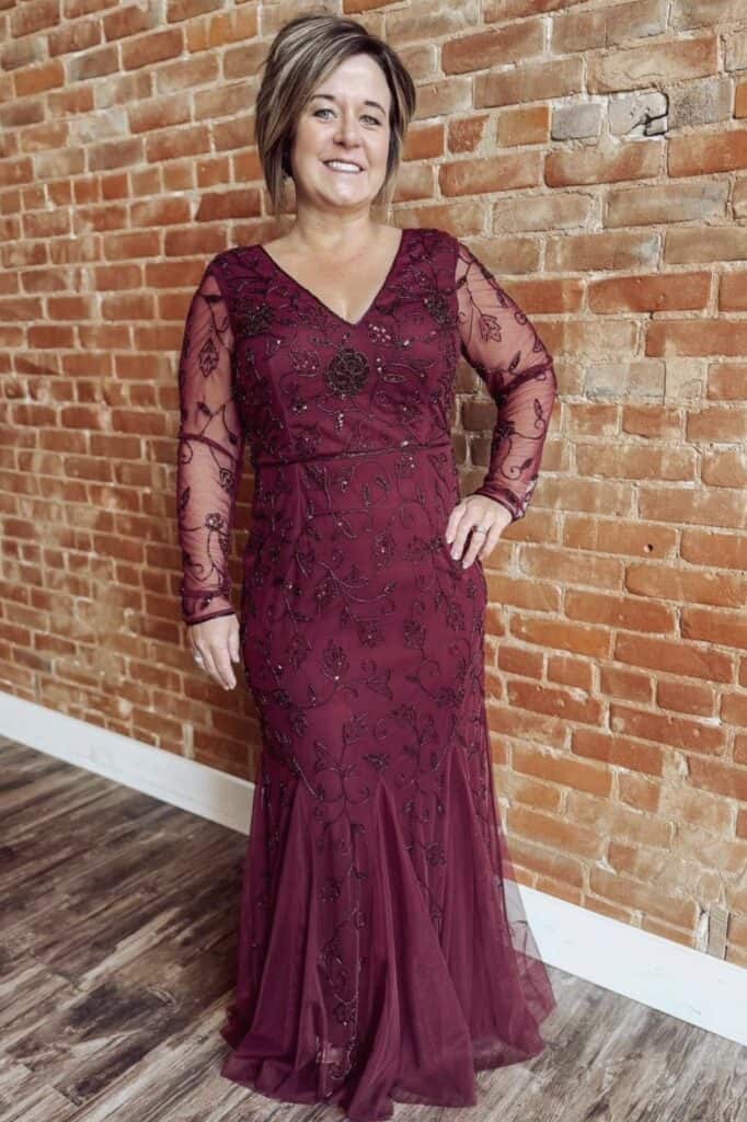 Elegant burgundy floral embroidered evening gown with sheer lace sleeves.