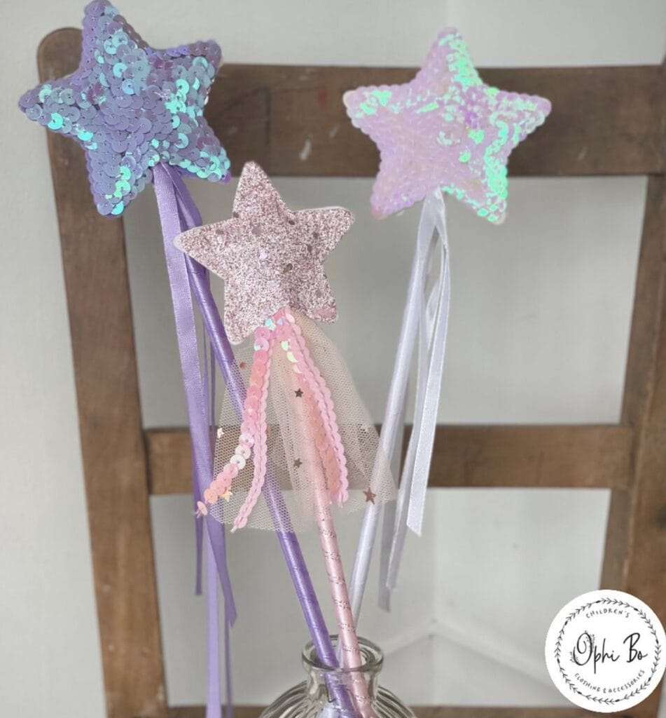 Colorful star and magic wand party decorations with sequins and tulle for children's celebrations.