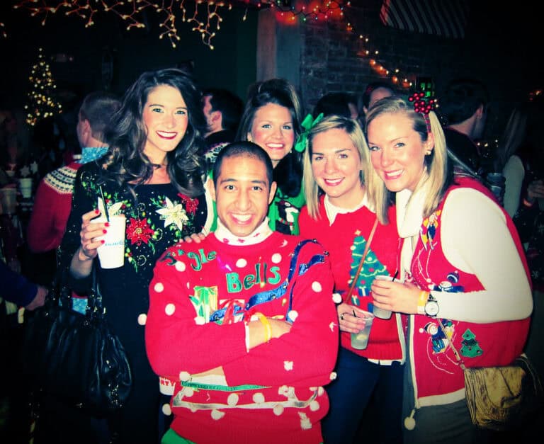 Festive Christmas party with friends, holiday sweaters, and colorful decorations at Confetti & Roses.
