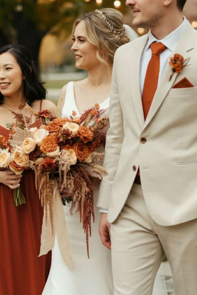 Autumn-themed wedding with floral bouquet in warm tones.