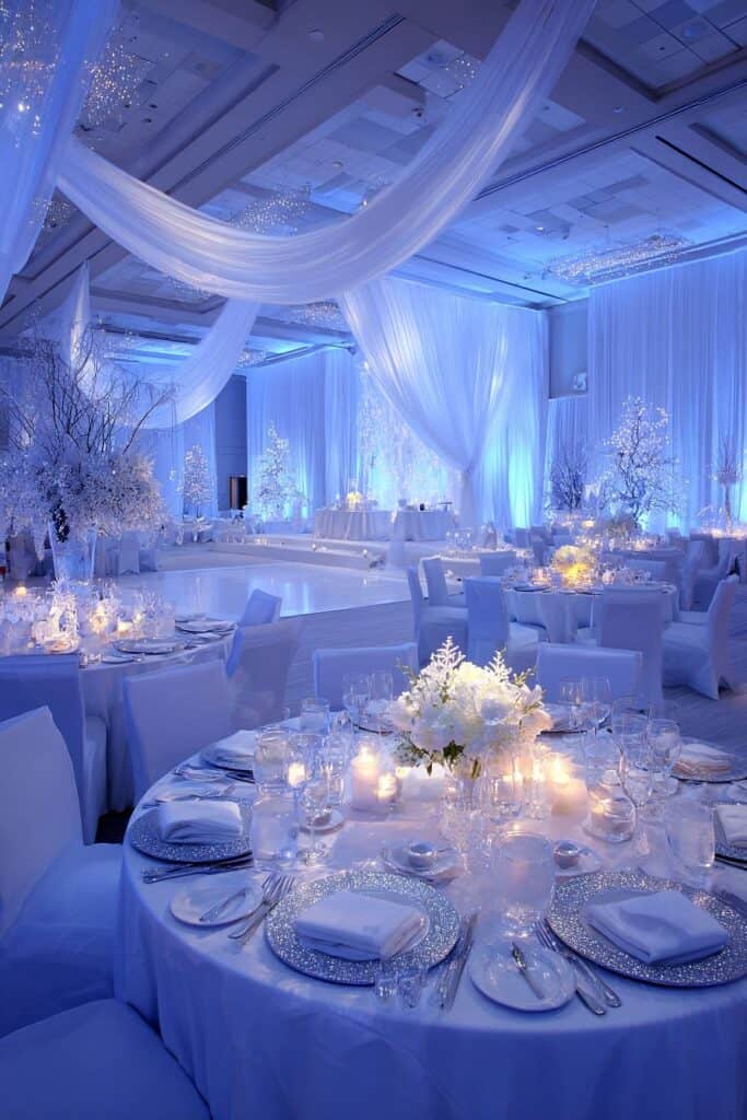 Elegant winter wedding reception decorated with white floral centerpieces and candlelit tables.