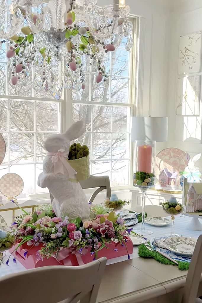 Colorful Easter table decor with bunny, flowers, and spring accents.