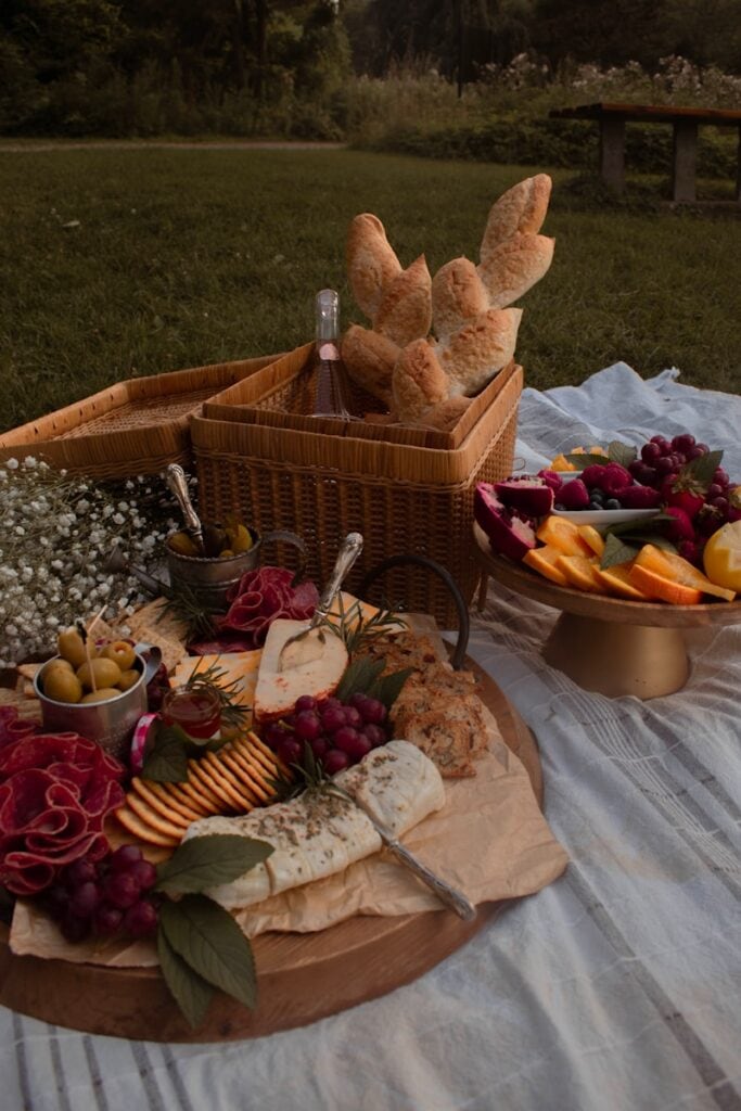 bread and sliced fruits on brown woven basket beautiful picnic