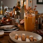 a wooden table topped with plates of food and drinks