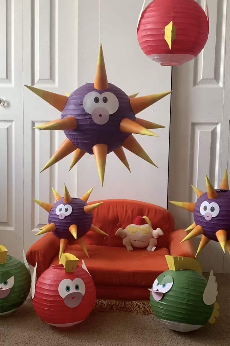 A colorful DIY Mario-themed birthday party decoration with spiky purple and red paper lanterns resem.