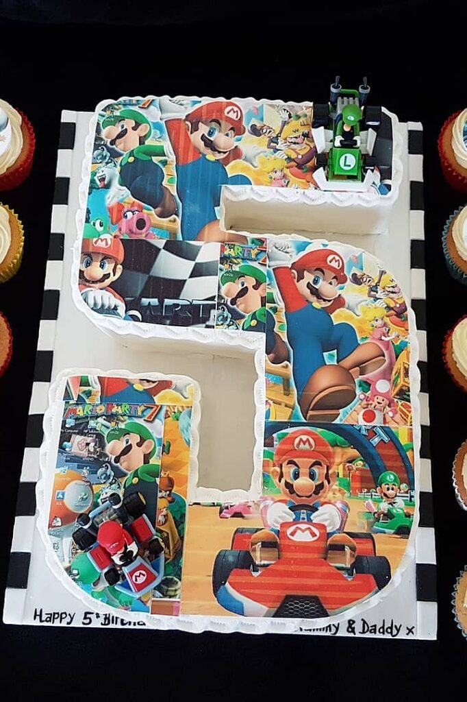 Mario-themed birthday cake with Super Mario characters and racing elements for a nostalgic celebrati.
