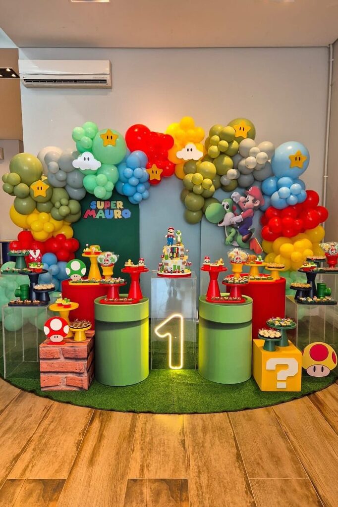 Super Mario themed birthday party setup with colorful balloons and cake table decor.