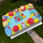 Super Mario-themed birthday cake with colorful decorations and characters for kids' celebration.