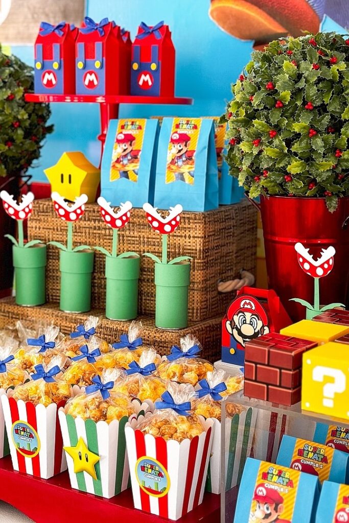 Mario-themed birthday party decorations with colorful treats and themed tableware.