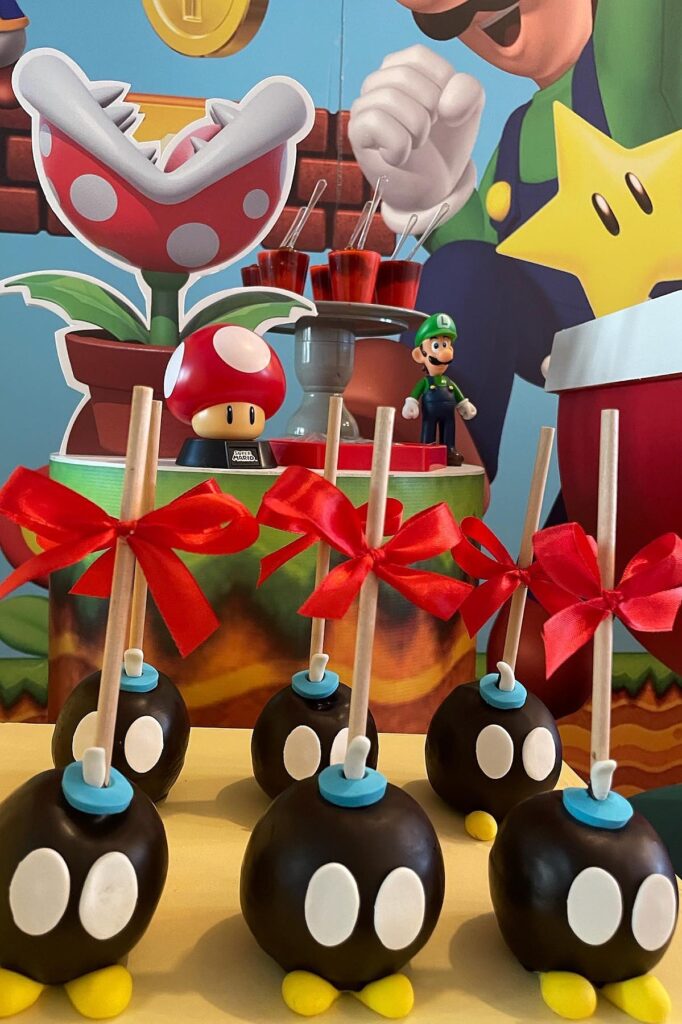 A colorful Super Mario themed birthday cake with mushroom and star decorations for a nostalgic party.