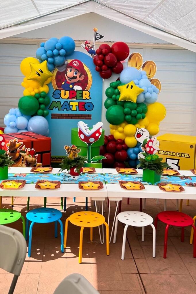 Super Mario themed birthday party decorations with balloons and table setup.