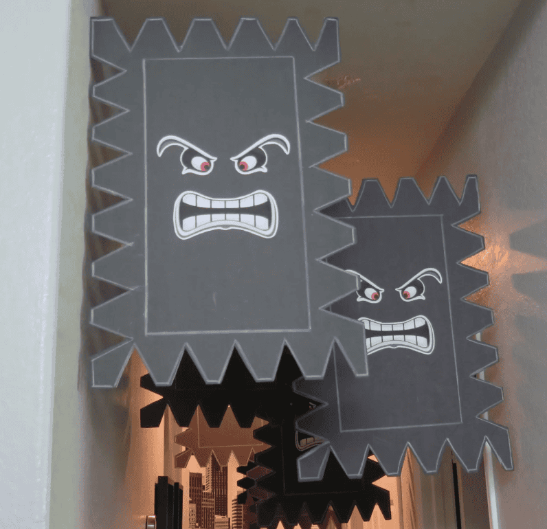 A menacing paper craft of Bowser's face from Mario with angry eyes and sharp teeth, Halloween decora.