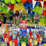 Mario-themed birthday party decorations with colorful balloons and Super Mario figures.