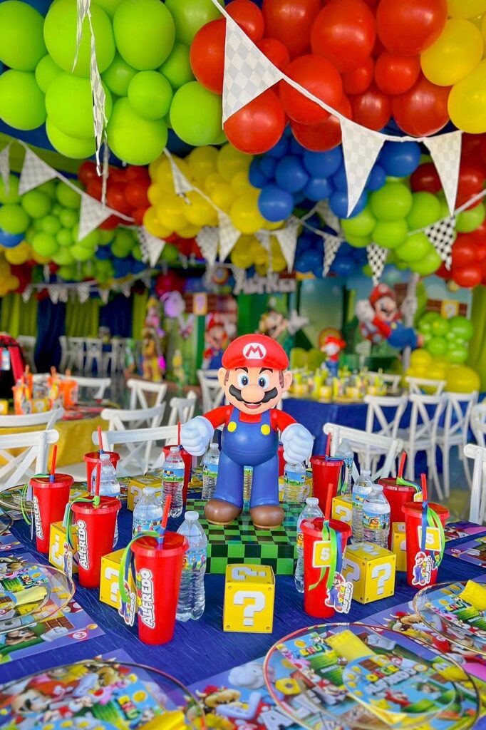 Mario-themed birthday party decorations with colorful balloons and Super Mario figures.