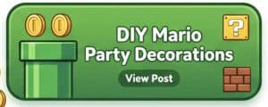 A colorful DIY Mario-themed party decoration featuring a green pipe, brick block, and question mark.