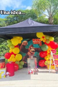 A colorful Donkey Kong-themed birthday party setup with balloons, banners, and decorations.