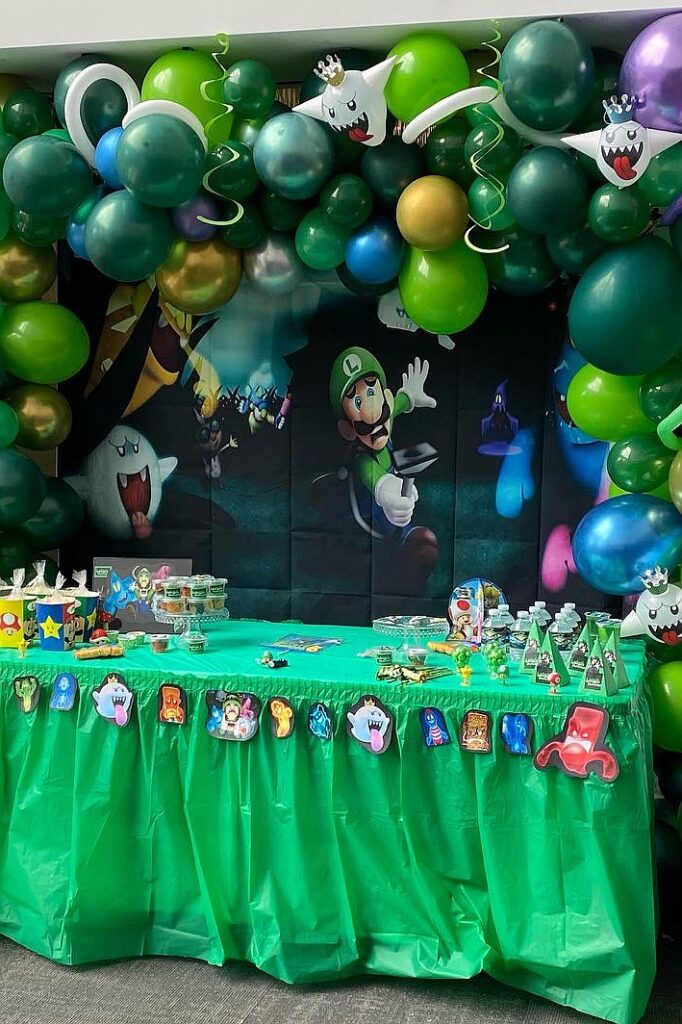 A colorful Luigi's Mansion themed birthday party setup with balloons and themed decorations.