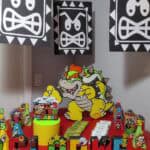 A colorful Bowser-themed birthday party setup with decorations, cake, and themed toys for a child's.