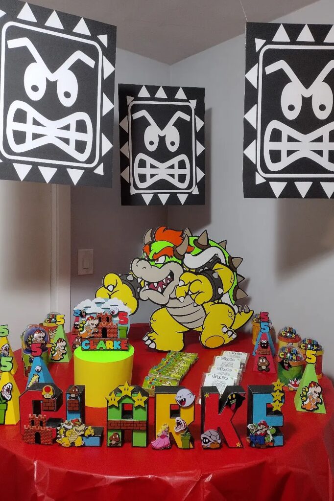A colorful Bowser-themed birthday party setup with decorations, cake, and themed toys for a child's.