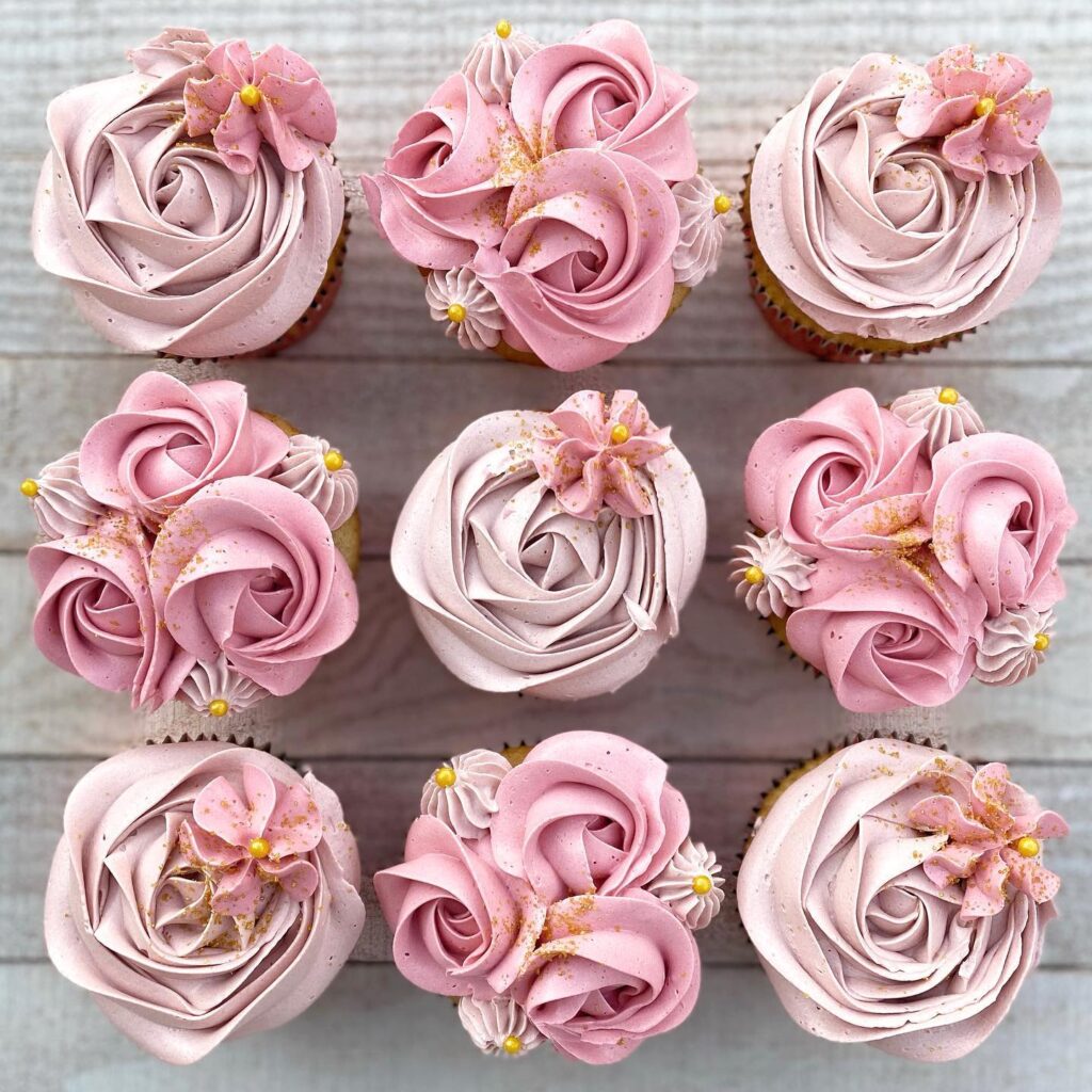 Beautiful pink and white wedding cupcakes with floral decorations for wedding celebration.
