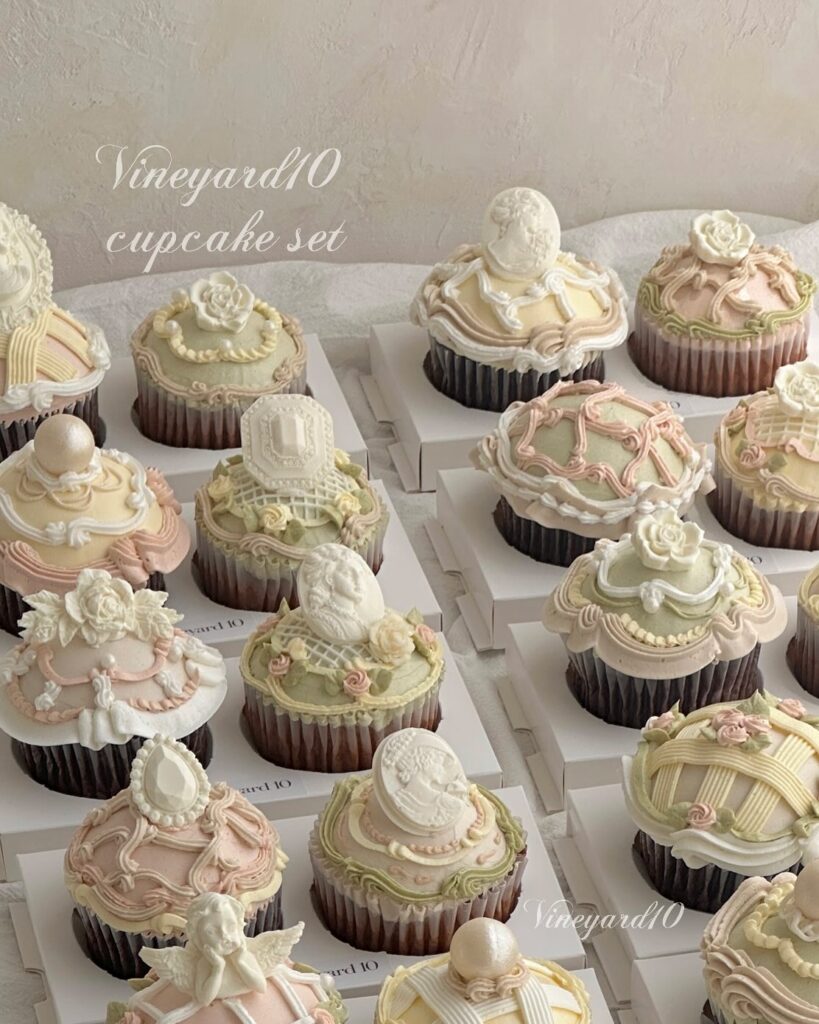 Elegant wedding cupcakes with pastel icing and floral decorations on a white display.