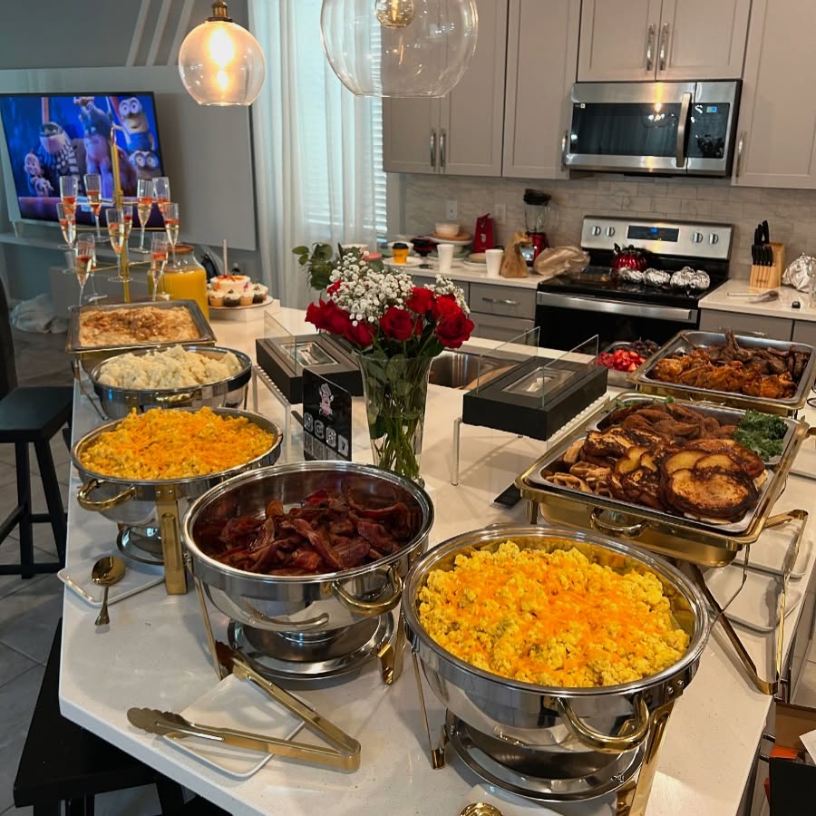 Thanksgiving feast with turkey, side dishes, and festive decorations in a modern kitchen.