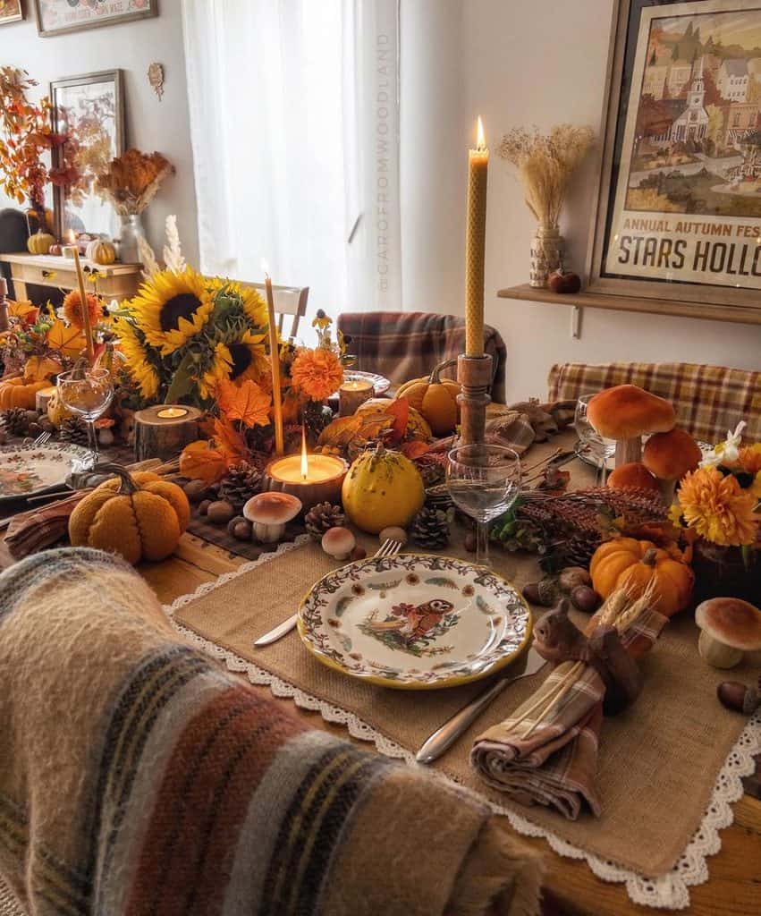 Fall-themed table setting with pumpkins, sunflowers, candles, and autumn decor for a cozy gathering.