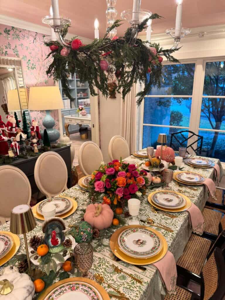 Elegant vintage Thanksgiving tablescape with floral centerpiece, candles, and seasonal decor.