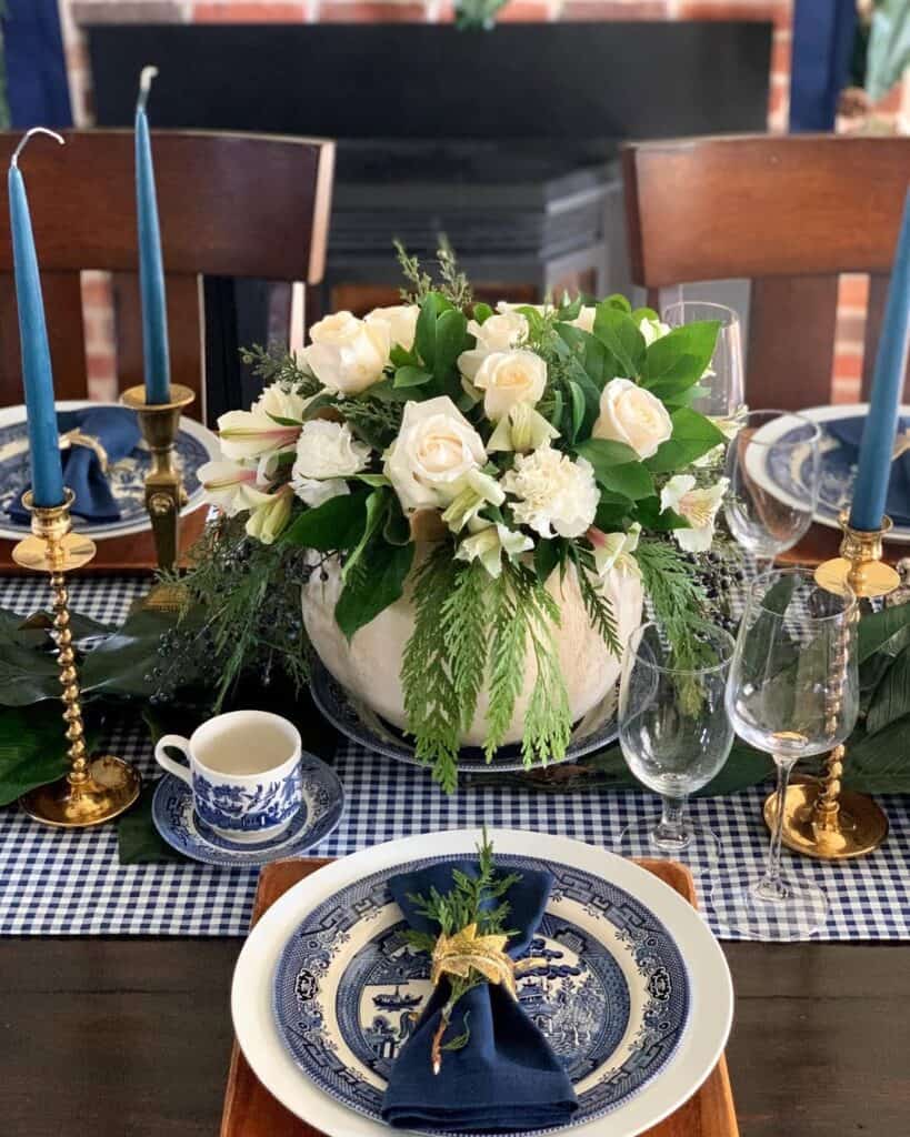 Elegant Thanksgiving table setting with white roses and blue accents.