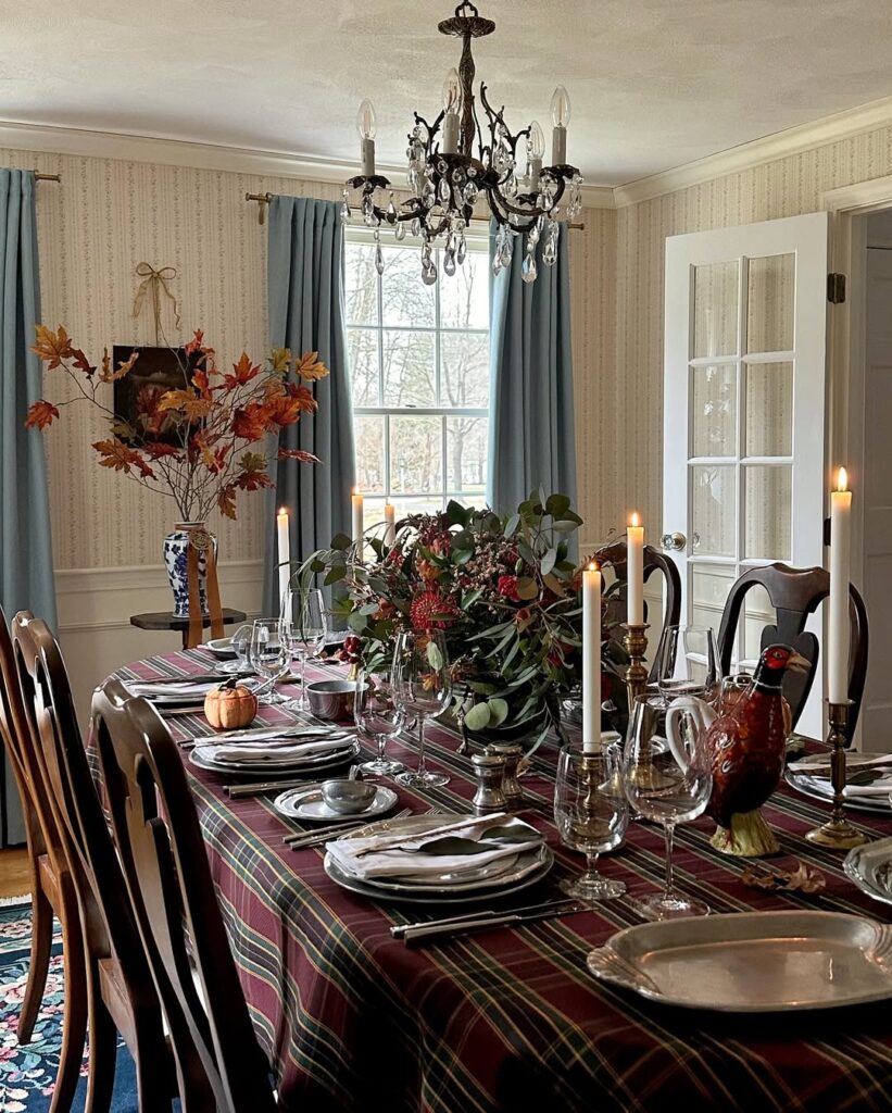 Elegant Thanksgiving dining table with fall decor, candles, and floral centerpiece.
