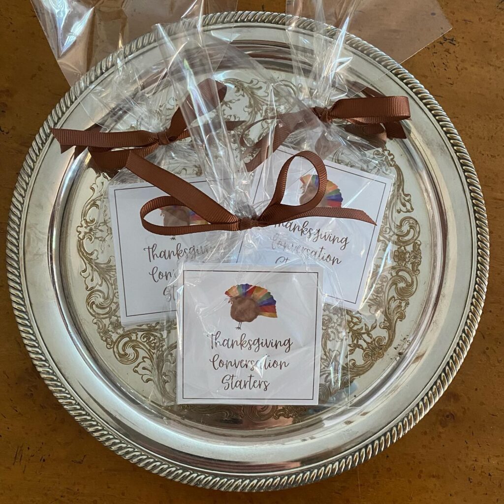 Thanksgiving themed lion starters on a decorative silver tray with ribbons and labels.