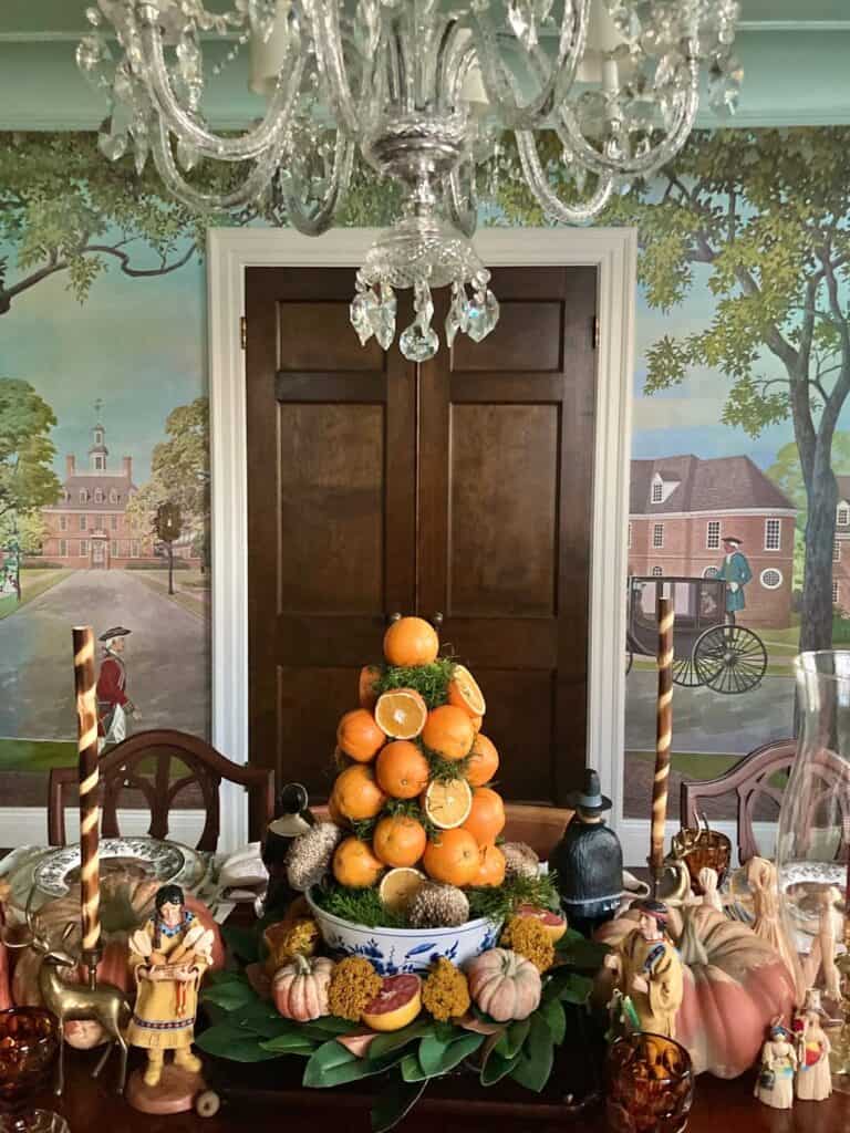 Vintage Thanksgiving tablescape with pumpkin centerpiece and old-fashioned decor.