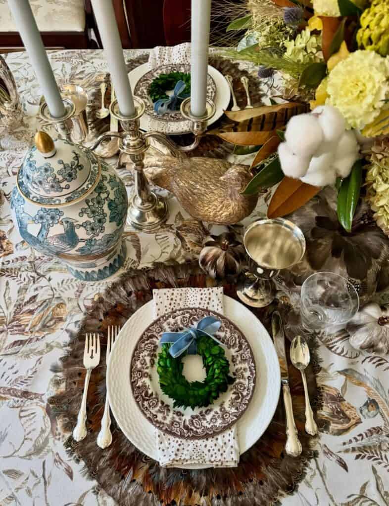 Vintage Thanksgiving tablescape with floral centerpiece, candles, and festive decor.