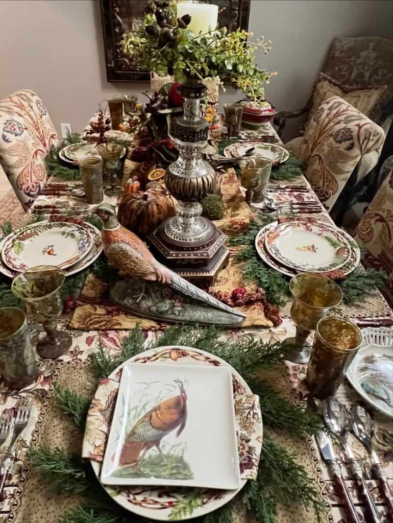 Vintage Thanksgiving tablescape with floral china, candles, and autumn decor.
