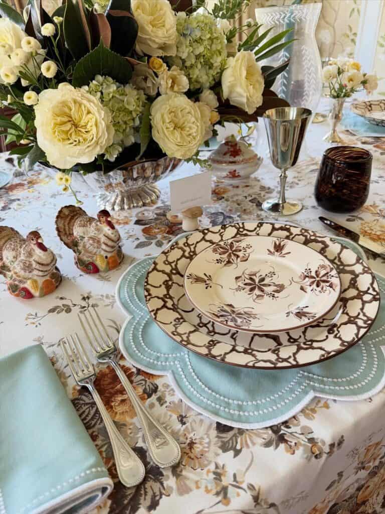 Vintage Thanksgiving tablescape with floral centerpiece, elegant china, and antique decor.