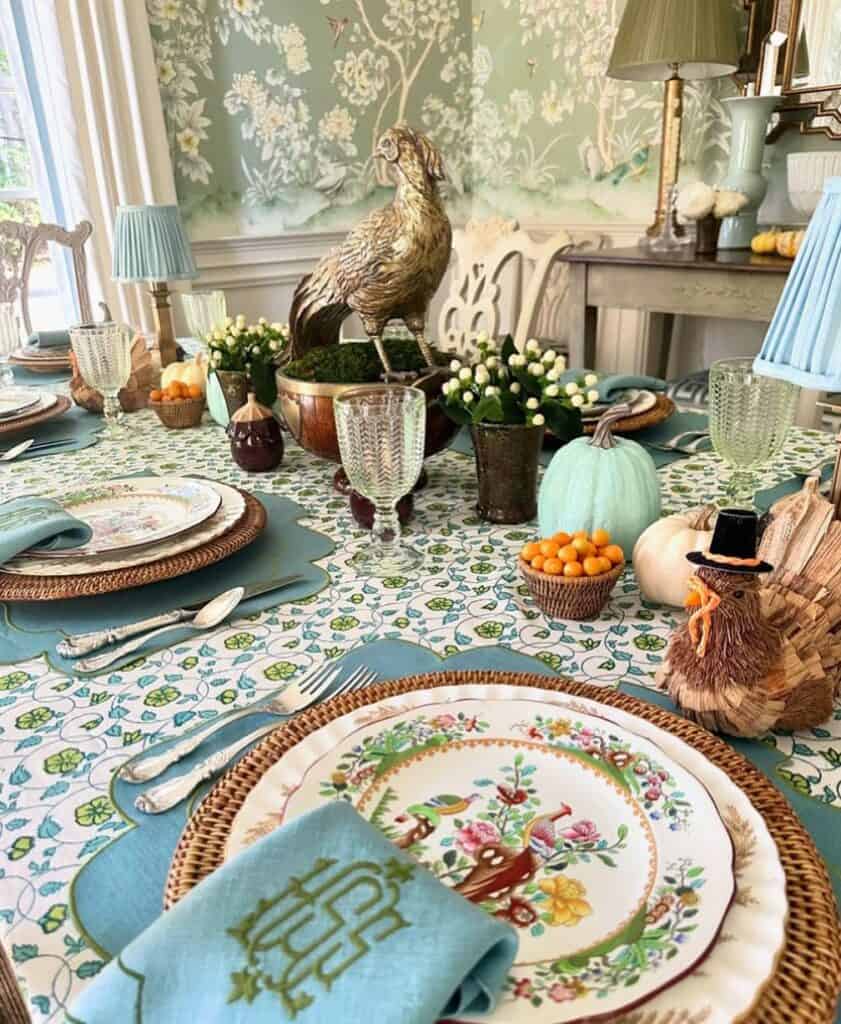 Vintage Thanksgiving tablescape with floral china, pumpkins, and autumn decor.