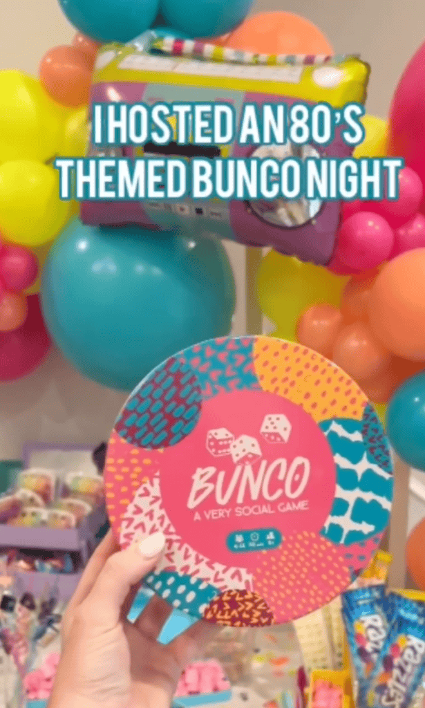 Colorful balloons and a Bunco game set for an 80s themed Bunco night party.